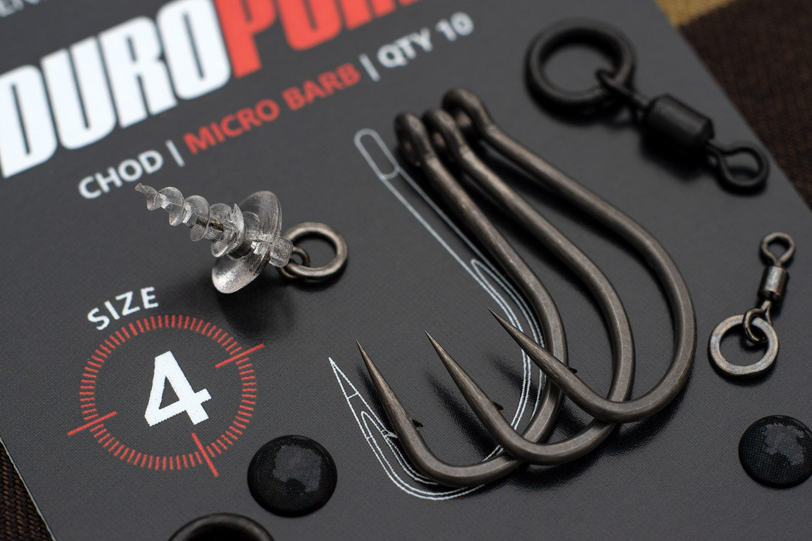 Three razor sharp Duropoint Chod carp hooks in a size four, pictured with a variety of hinged stiff rig components,. Look at those chemically sharpened points. Are they the sharpest from the packet? We think so!