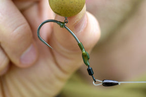 A needle sharp Size 2 Duropoint Curve shank hook as part of a Spinner / Ronnie Rig with Green hook beads and green Shrink tubing.