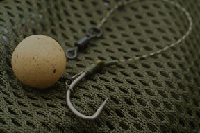 Tufflex Camo Pva Bag and Snag Braid with its Khaki and Brown fleck dissapears on a weedy lake bed, Its soft and natural behaviour means Carp wont spook when feeding over your rig. Pictured here is a Slip D Rig with a Continental Hook, rig swivel and wafter.